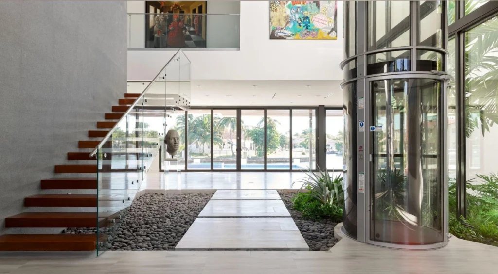 Compact glass elevator in a luxury open-plan home.