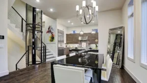 Compact residential elevator installed next to a staircase in a luxury home, highlighting the practicality and elegance of modern vertical mobility solutions