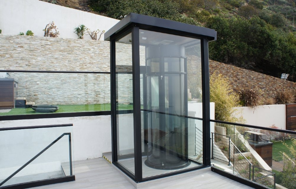 Exterior view of a residential vacuum home elevator installed in a modern multi-level home