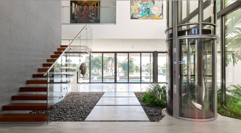 Glass home elevator with panoramic design in a modern luxury home